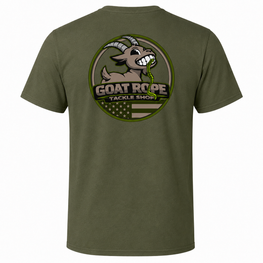 An olive green short-sleeve t-shirt shown from the back, featuring a large circular graphic print of a cartoon goat with horns and the text 'GOAT ROPE TACKLE SHOP' over a circular American flag design.