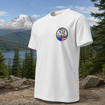 A white short-sleeve crewneck t-shirt with a circular 'GOAT ROPE' logo printed on the left chest, set against a background of a mountain, lake, and pine forest.