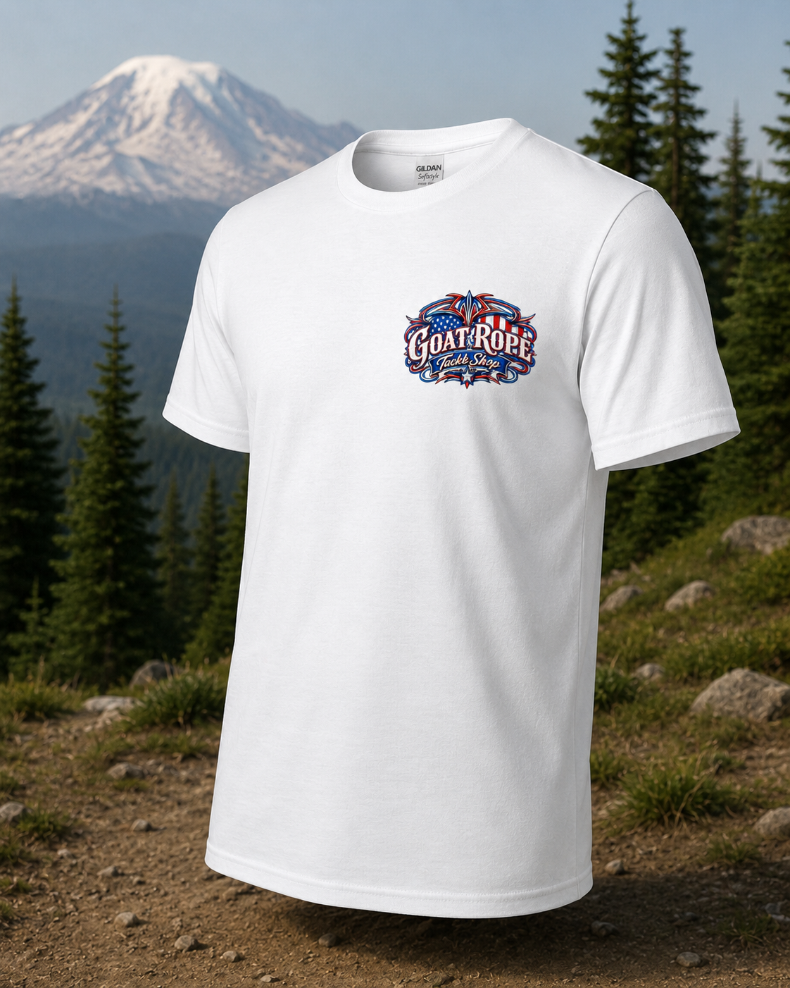 A white short-sleeve t-shirt with a colorful 'Goat Rope' graphic on the chest, displayed against a background of a snowy mountain and pine forest.
