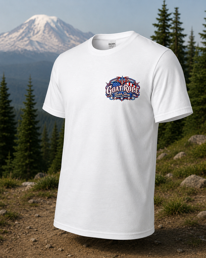 A white short-sleeve t-shirt with a colorful 'Goat Rope' graphic on the chest, displayed against a background of a snowy mountain and pine forest.