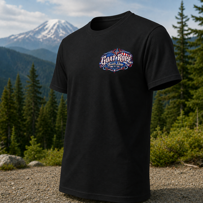A black short-sleeve t-shirt with a colorful 'Goats Rope' logo on the chest, displayed against a scenic mountain and forest background.